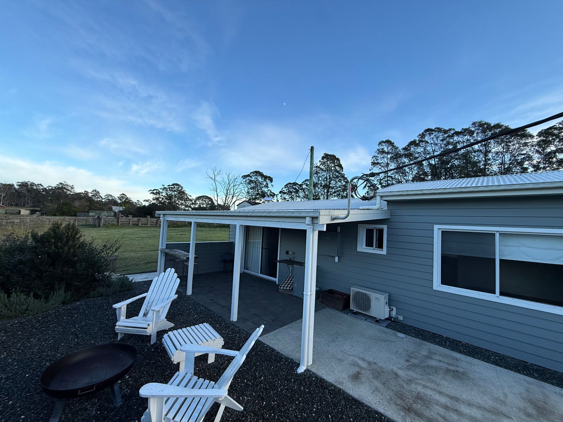 Deck chairs and firepit outside the self-contained cottage