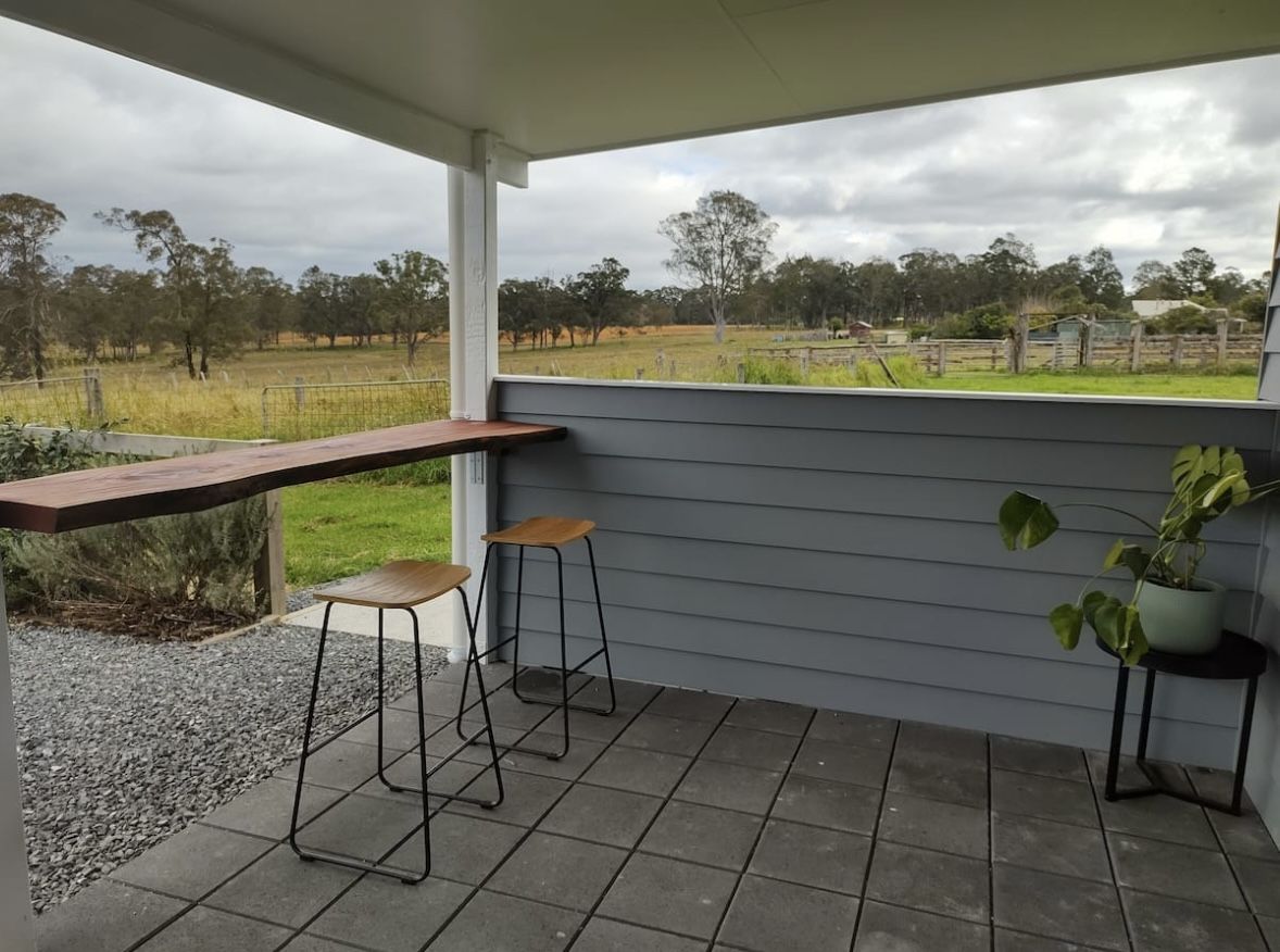 Covered deck with bar seating looking over the farm