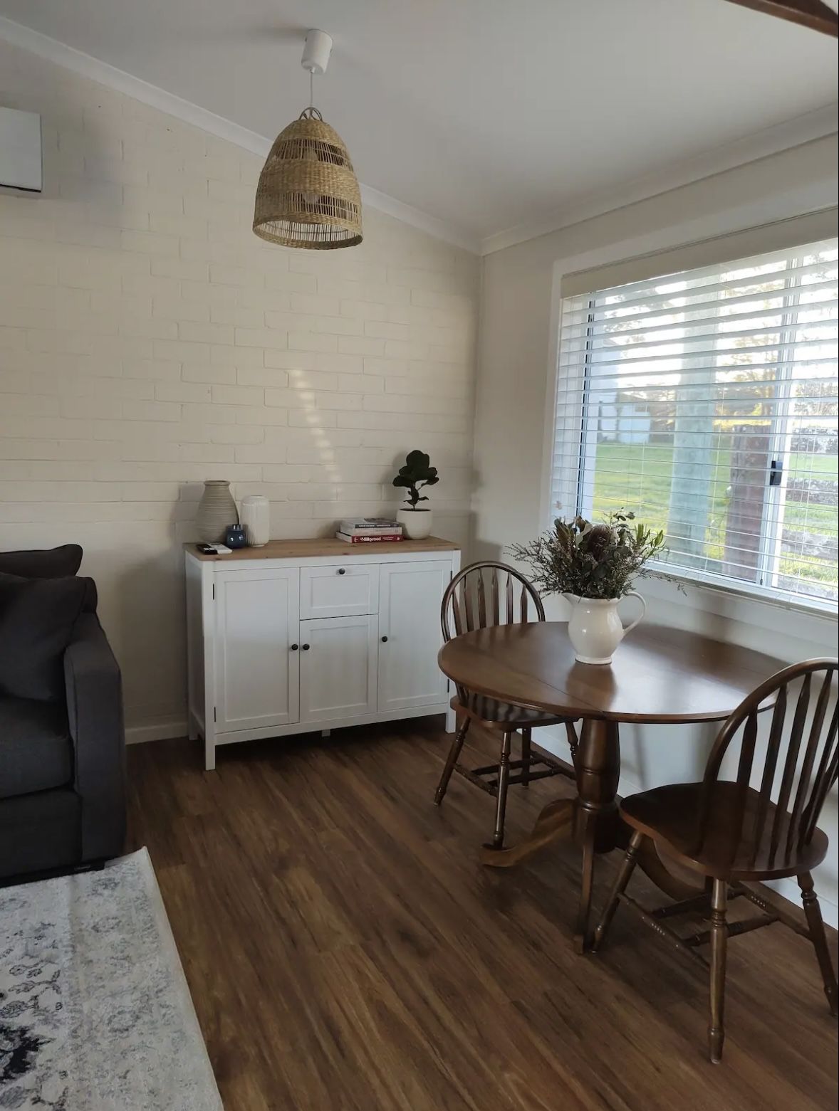 Dining table for two beside the window in the cottage living area